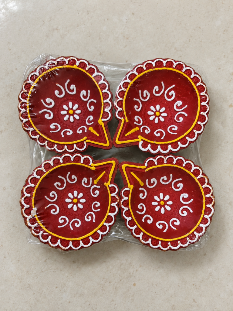 Four red painted diyas