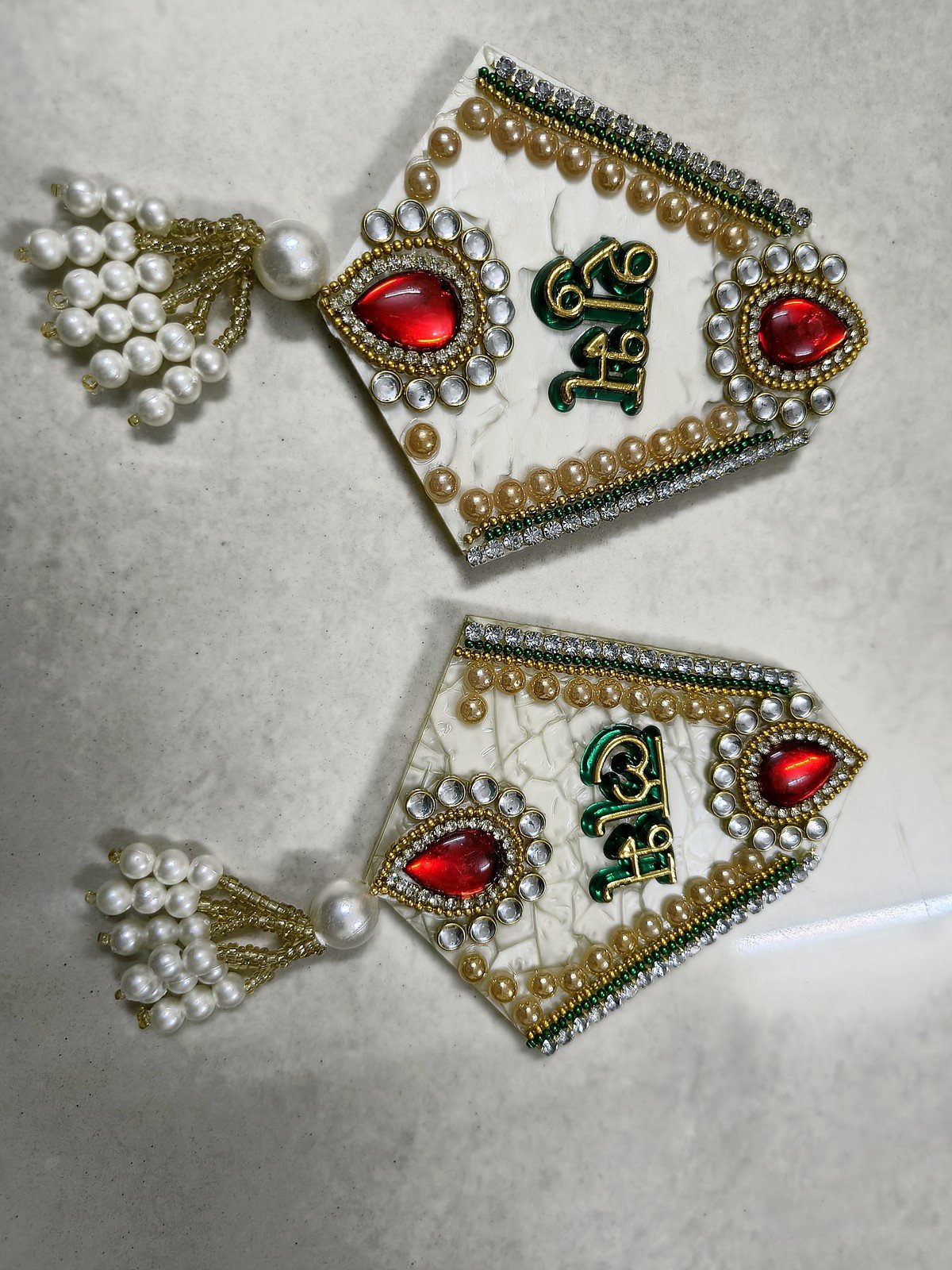 White Shubh Labh hangings with kundan stones and pearl tassels