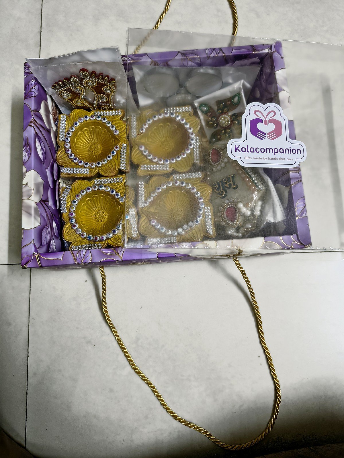 Swarna Roshni Golden Diya Hamper: packed in the floral gift box