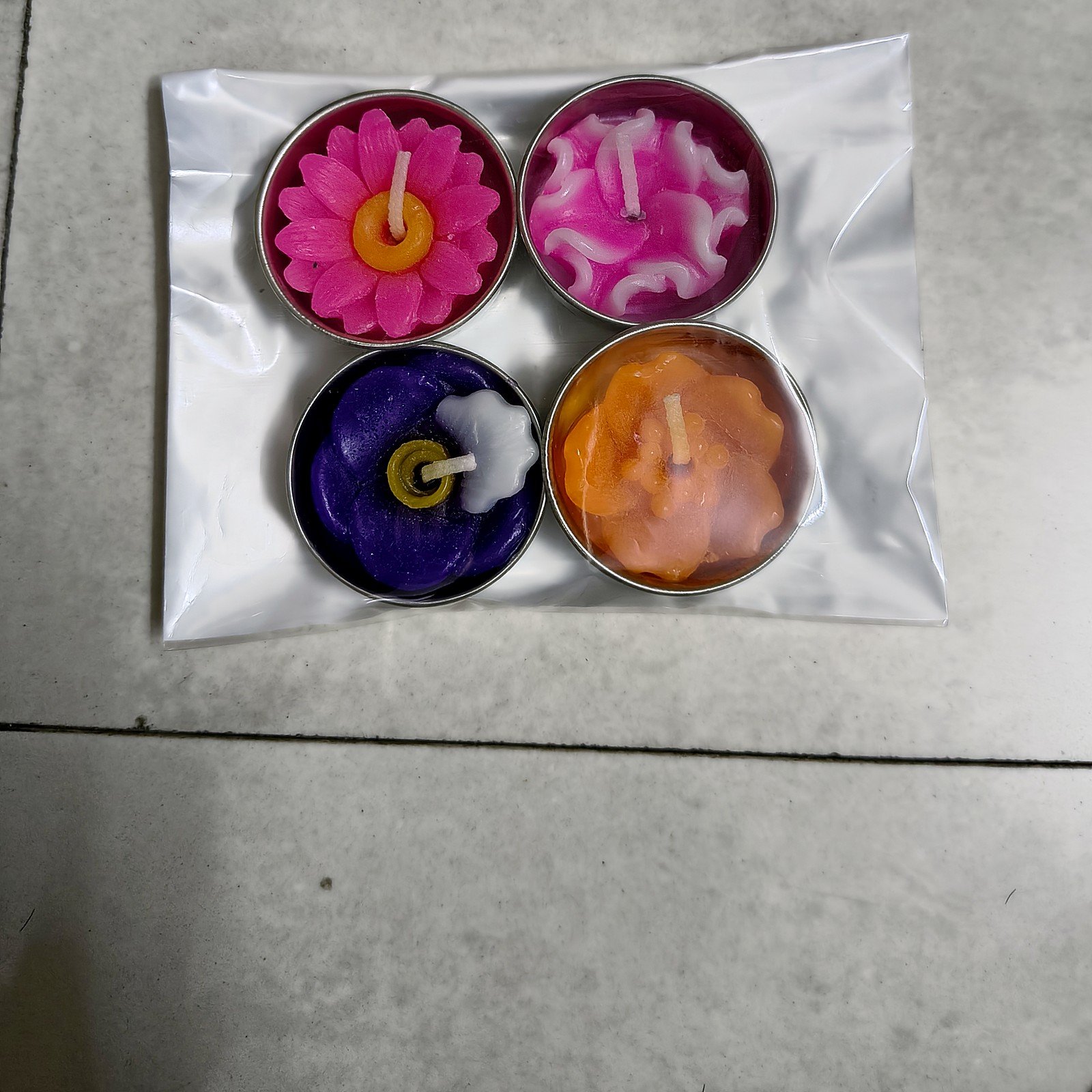 Swarna Tarang Golden Diya Hamper: four flower-shaped floating candles